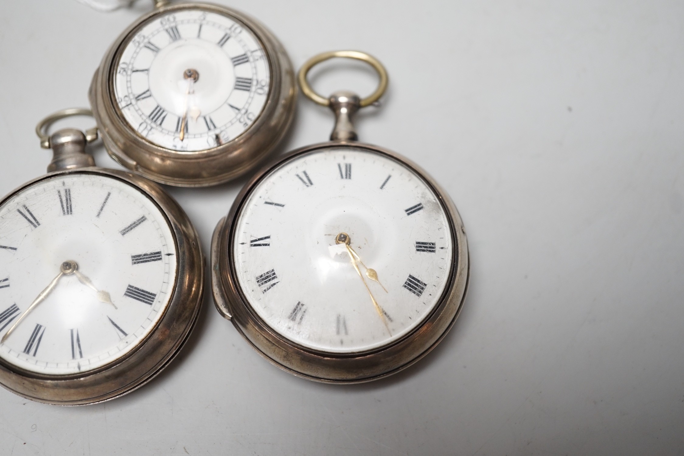 An 18th century silver pair cased keywind verge pocket watch, by Sam Toulmin, London, a similar watch by Tomlin, London and one other silver pair cased pocket watch with unsigned movement.